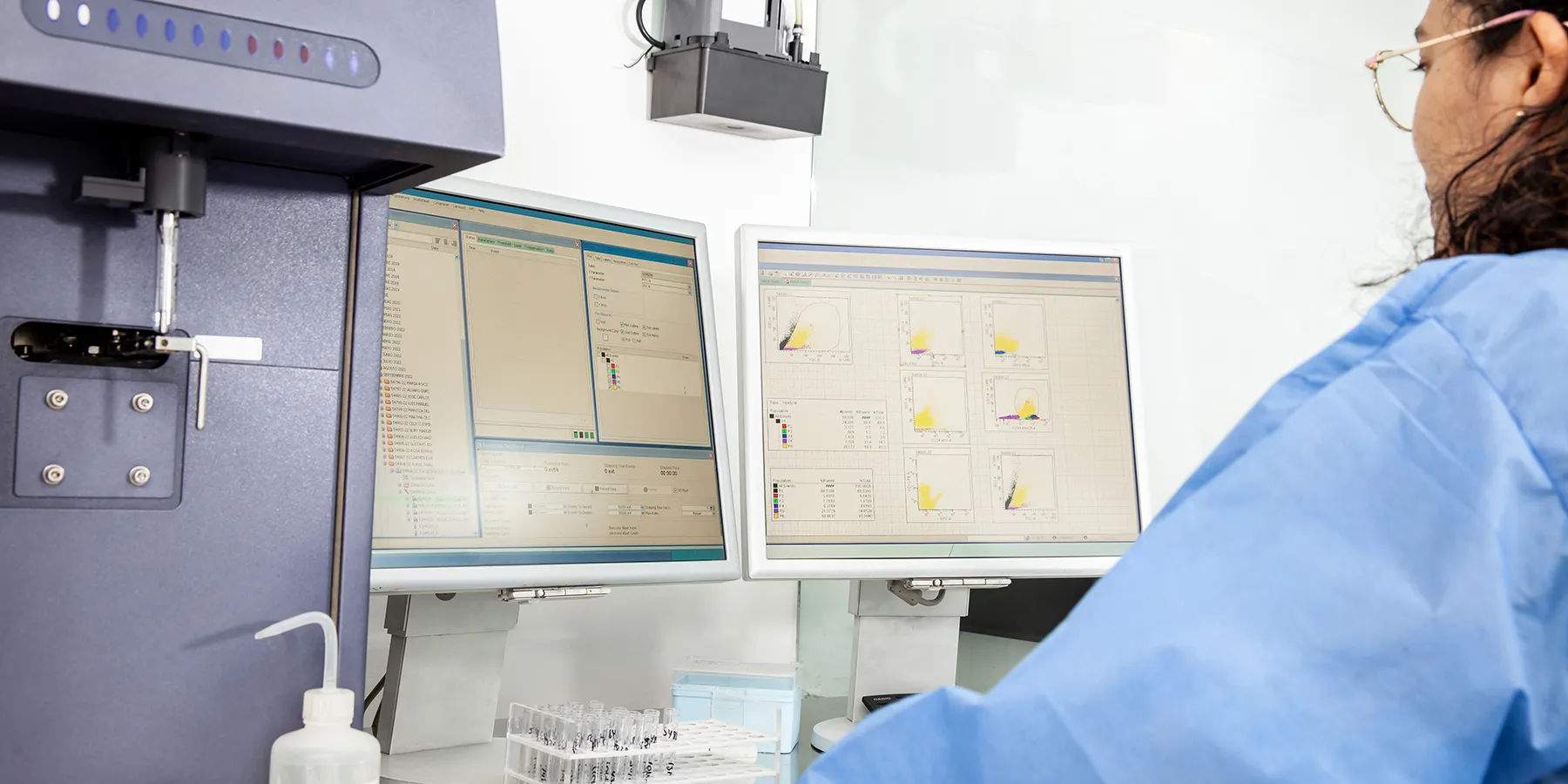 Photo of a clinical laboratory scientist wearing PPE and performing a flow cytometry analysis on T cells in diabetes samples.