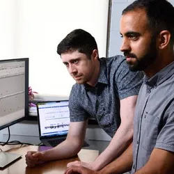 Photo of Johns Hopkins geneticists Dylan Taylor (left) and Rajiv McCoy in their clinical genetics laboratory.