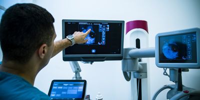 Clinician examining a breast mammogram.