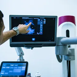 Clinician examining a breast mammogram.
