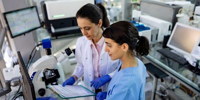 Medical laboratory scientists looking at test results