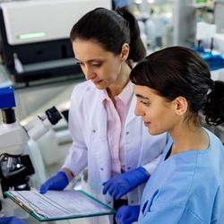 Medical laboratory scientists looking at test results