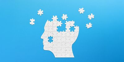  Illustration of a brain-shaped white jigsaw puzzle on blue background.