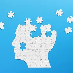  Illustration of a brain-shaped white jigsaw puzzle on blue background.
