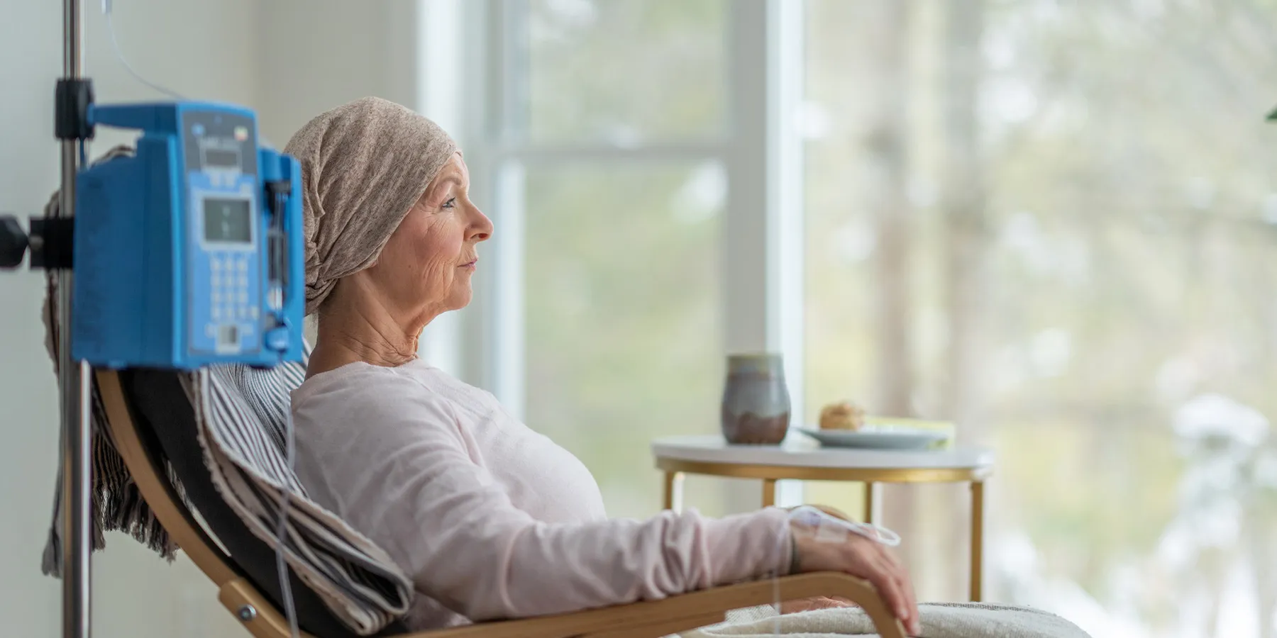 ovarian-cancer-test-receives-cpt-code-and-preliminary-payment-determination-from-cms Photo of a woman sitting in a hospital chair with an IV and undergoing treatment for ovarian cancer.
