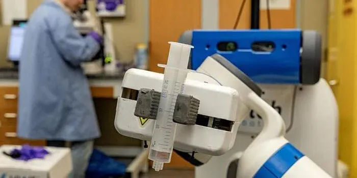 In this image, the Fetch robot is able to maneuver through the Cahoon Lab while holding a syringe on October 21, 2024, in the Caudill Labs building on the campus of the University of North Carolina at Chapel Hill.