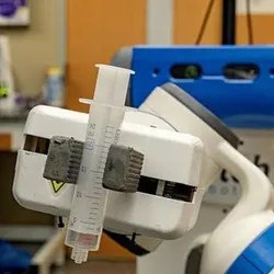 In this image, the Fetch robot is able to maneuver through the Cahoon Lab while holding a syringe on October 21, 2024, in the Caudill Labs building on the campus of the University of North Carolina at Chapel Hill.