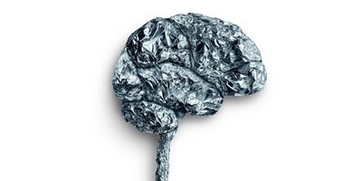 Photo of a shape in the form of the human brain sculped from aluminum foil on a white background.