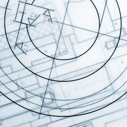 Photo looking down at different laboratory design blueprints.