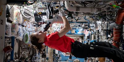 NASA astronaut Christina Koch working on MicroQuin's protein crystallization research on the ISS.