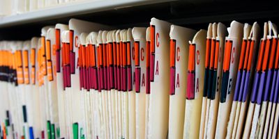 Photo of many patient files representing the thousands of participants enrolled in a study.