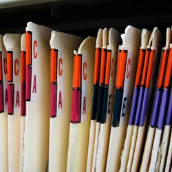 Photo of many patient files representing the thousands of participants enrolled in a study.