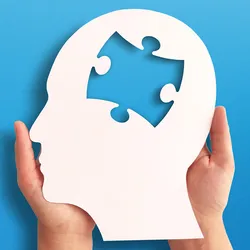 Photo of two hands holding a white cut-out of a human head profile with a puzzle piece missing from the brain on a blue background.
