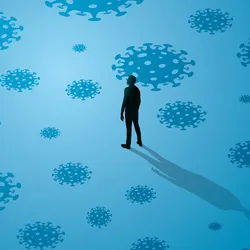 Illustration of a person standing alone in the middle of a large room with COVID-19 virus particles scattered around the blue background.