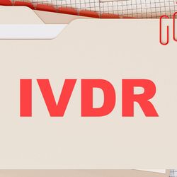 Photo of a document folder with the word “IVDR” on it in bold red letters and other office supplies on a desk.