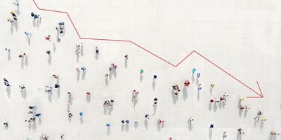 Photo looking down at a crowd from above outlined by a red arrow falling downwards like on a chart to represent the cutting of science and research funding in the US.