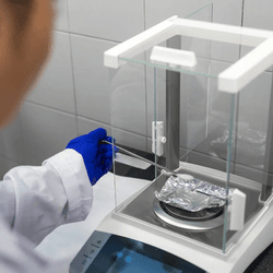 Scientist using an analytical balance