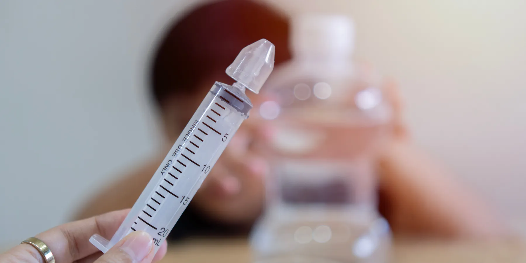 Photo of a nasal lavage syringe filled with sterile saline.