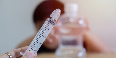 Photo of a nasal lavage syringe filled with sterile saline.