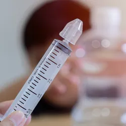 Photo of a nasal lavage syringe filled with sterile saline.