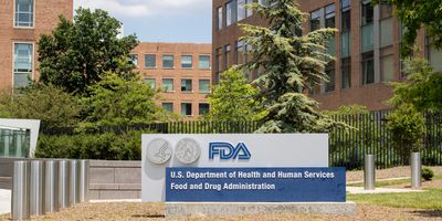 Photo of the main sign at the U.S. FDA Headquarters, White Oak Campus, showing buildings and trees in the background.