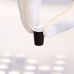 Gloved hand holding dry reagent cup