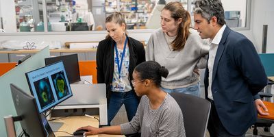 Elias Sayour (right) and lab members review research data.