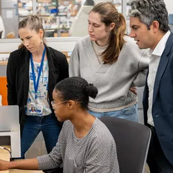 Elias Sayour (right) and lab members review research data.