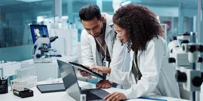 Two researchers working in a diagnostic lab with advanced testing solutions