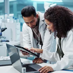 Two researchers working in a diagnostic lab with advanced testing solutions