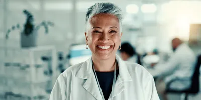 Clinical lab director smiling in a laboratory setting preparing to evaluate a new platform.