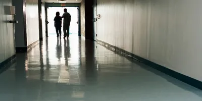 Health professionals walking in a hospital corridor responding to a possible drug overdose.